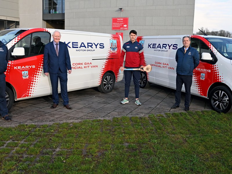 Kearys staff and a Cork GAA player with branded kit vans