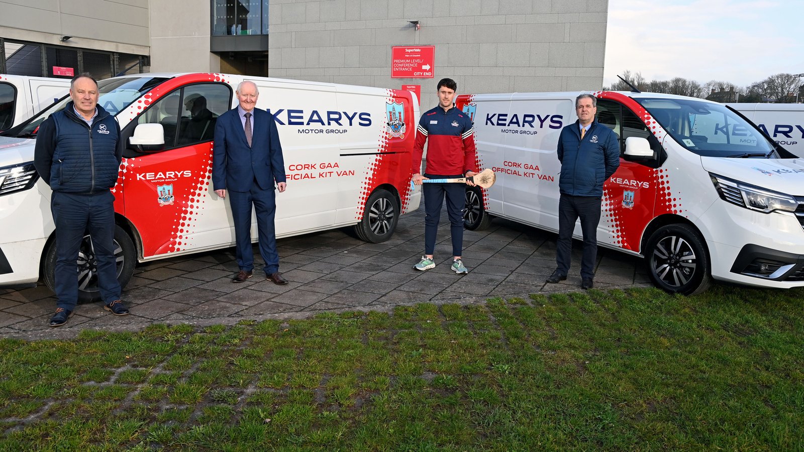 Kearys staff and a Cork GAA player with branded kit vans